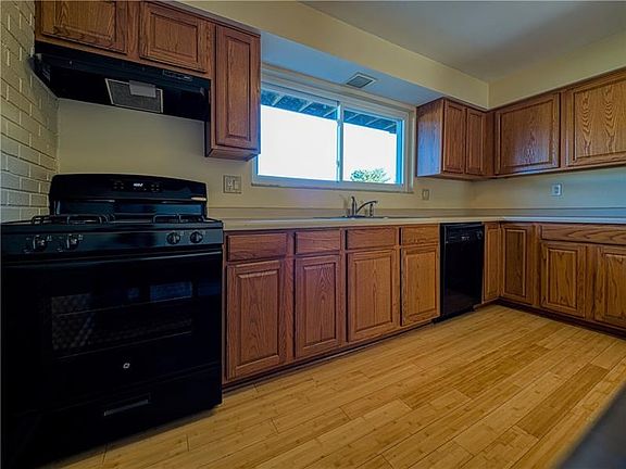 Black appliances compliment the abundant cabinetry and generous counter space.