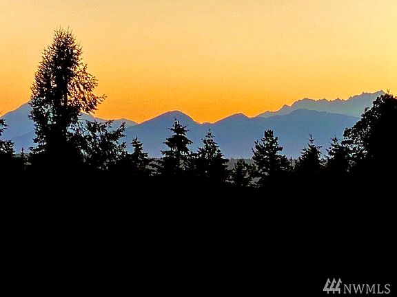 Sunset over the Olympics from Master bedroom deck.