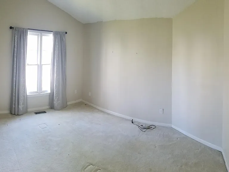 One of the two front bedrooms, both have since received new carpet.