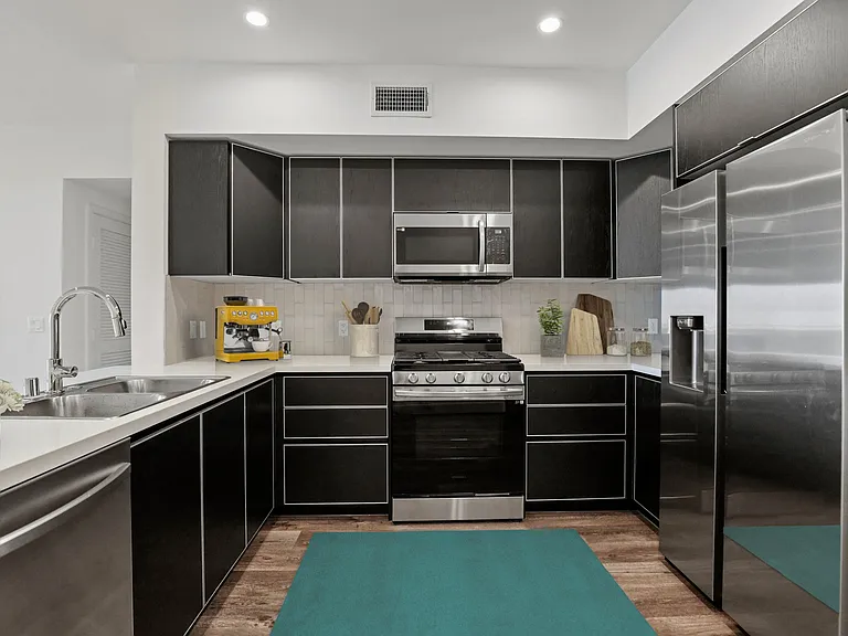 Spacious Kitchen with Stainless-Steel Refrigerator, Stove, Microwave Oven, and Dishwasher
