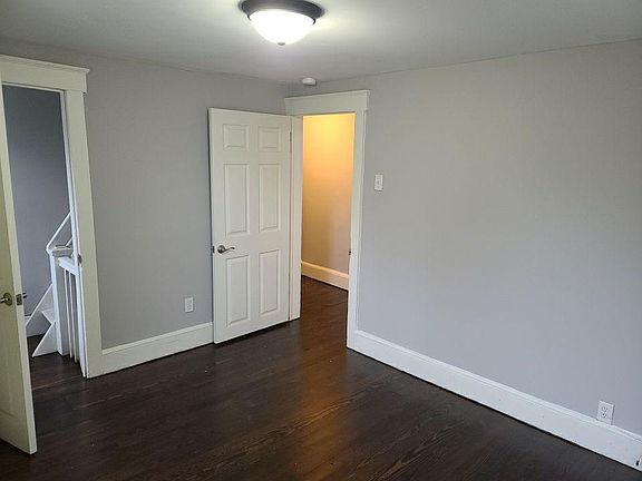 Large room freshly painted with multiple closets and new light fixtures