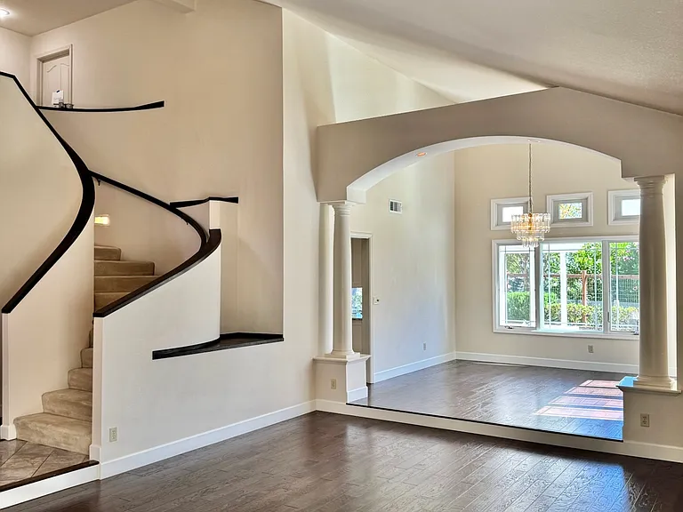 Beautiful open floor social space with living room and dining room featuring high ceilings