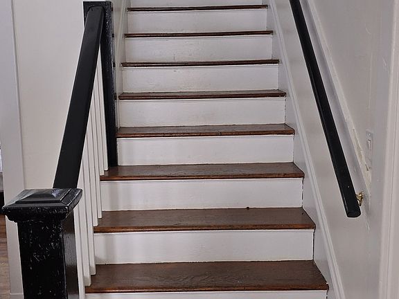 Stairway to upstairs bedrooms and full bath.