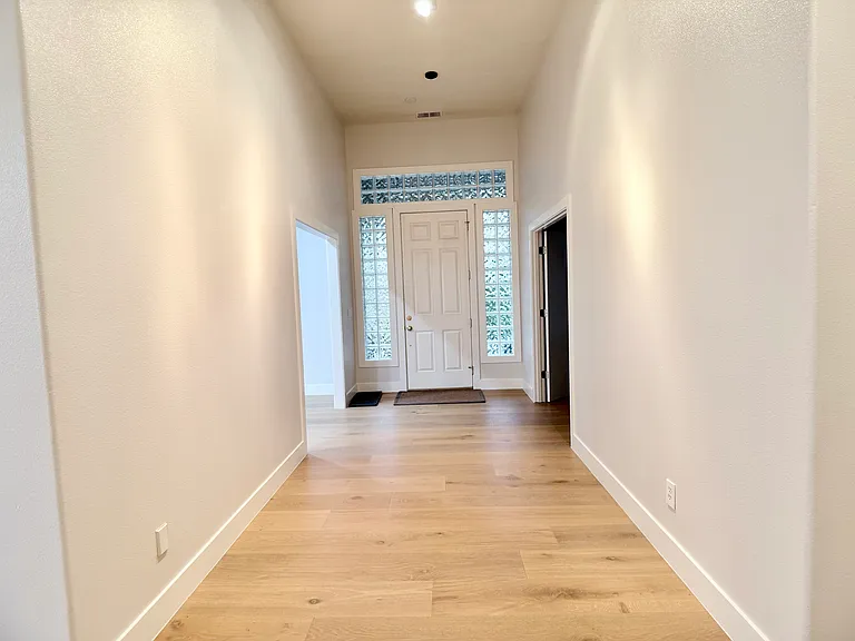 Bright, expansive entryway with high ceilings.