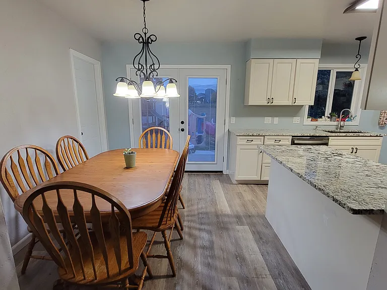 Dining room. French doors lead out to back yard. Door to left leads to garage.