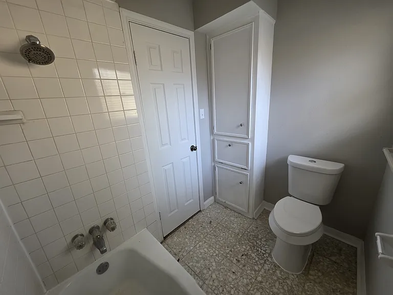 Shared / guest bathroom with more cabinets with shower & bath combo.