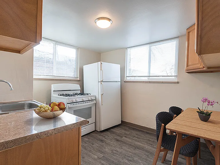 Bright and cozy kitchen with wooden cabinets, modern appliances, and a charming dining nook.