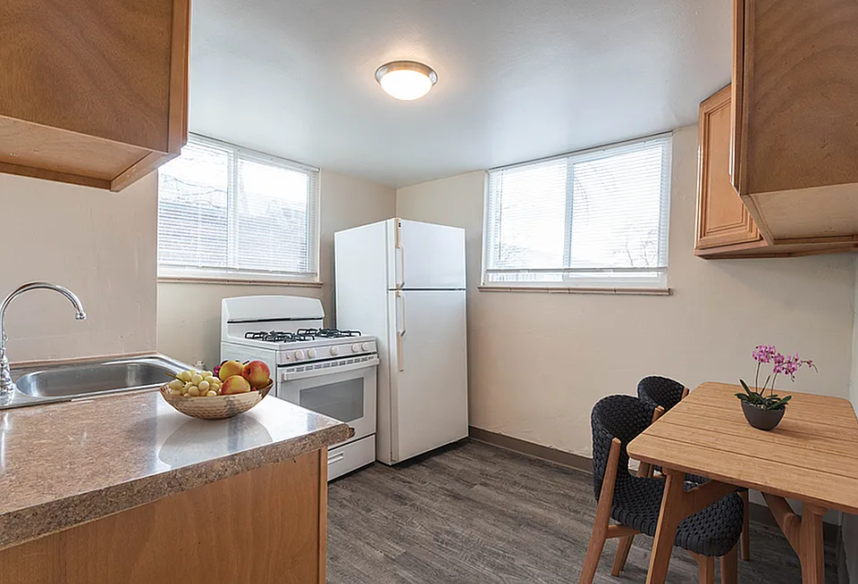 Bright and cozy kitchen with wooden cabinets, modern appliances, and a charming dining nook.