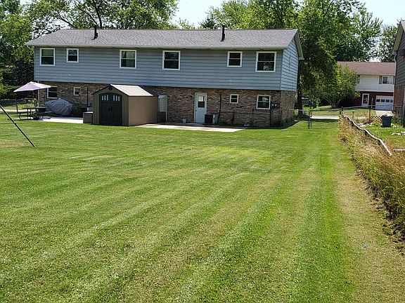 Rear picture of large fenced in back yard