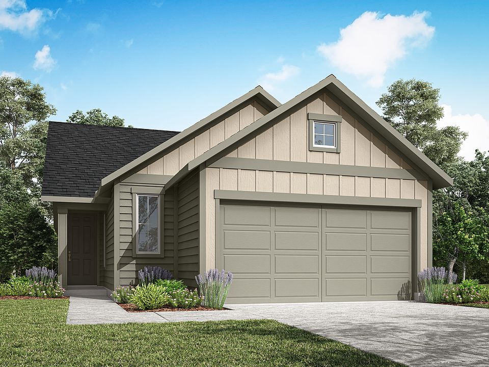 A two-story house with a gabled roof, beige siding, and a garage door sits on a grassy lawn surround