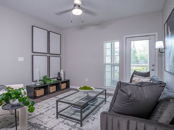 Find ultimate comfort in our living room, where a glass door invites you to a serene screened-in patio.