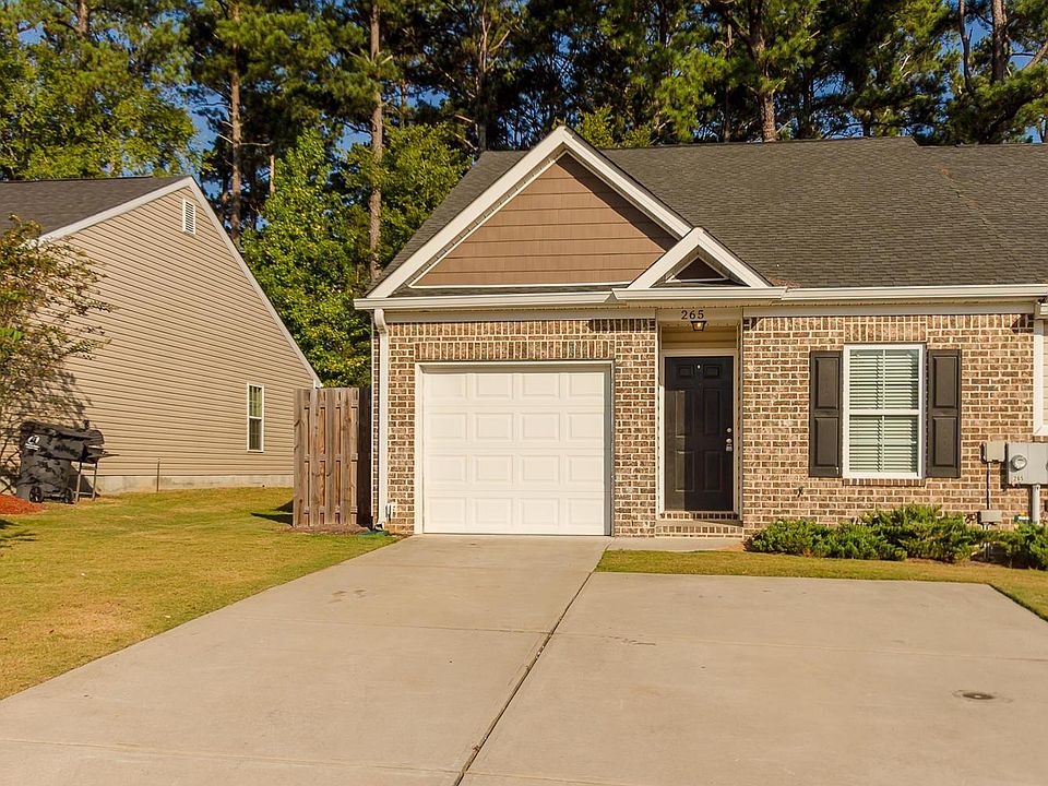 End unit! large parking pad plus one car garage with ample s