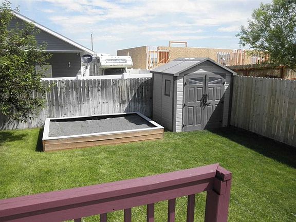 sandbox and shed in backyard