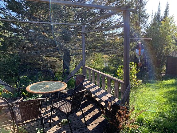 Deck off the kitchen overlooking pond.