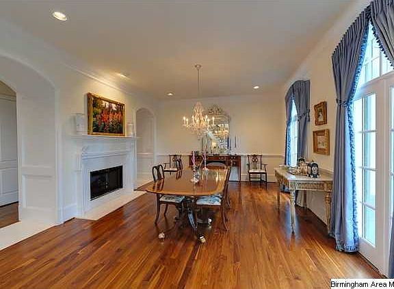 Formal Living Room, 10' ceilings are accented with 8 pc crown molding, beautiful WALNUT hardwood floors, Gas fireplace with marble surround, Arched windows with custom drapes inspired by Providence Paulin, and Barrel Vault Doorways