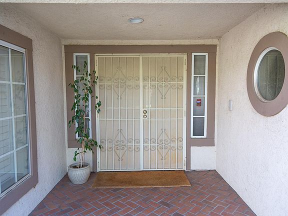 The front entrance is protected by both a screened, metalsecurity door and a solid wood door.