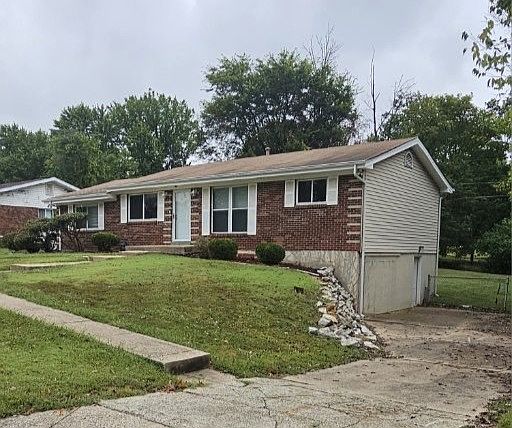 Front of house showing right driveway and walk-out basement door