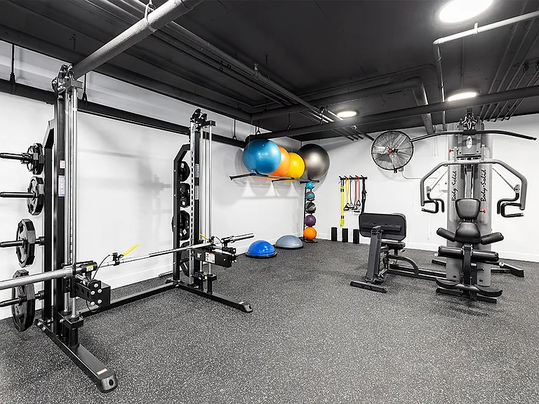 Fitness center Including cycling bikes, ellipticals, treadmills, free weights, and stretching balls.