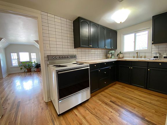 Charming black, white, & gold kitchen.