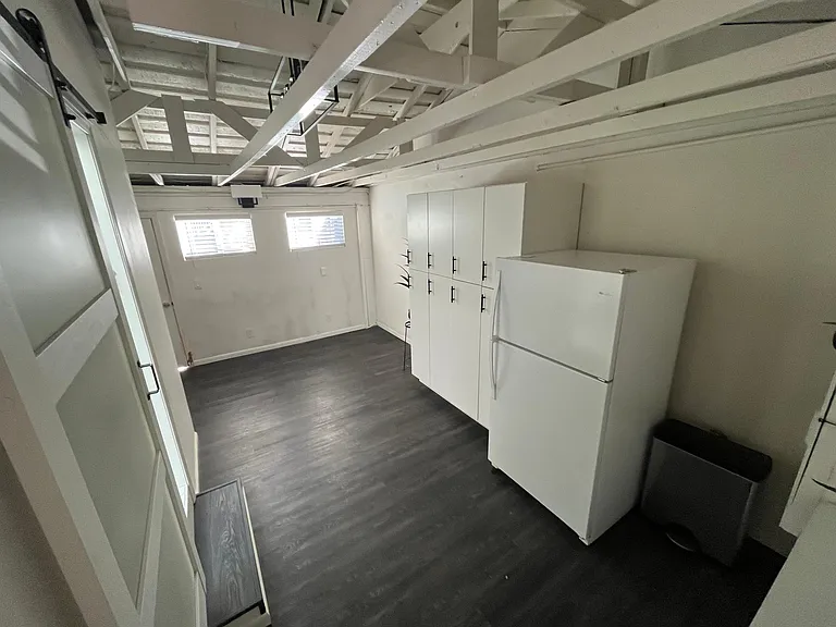 Bonus room view from back patio. New fridge and built-in cabinets for tons of storage