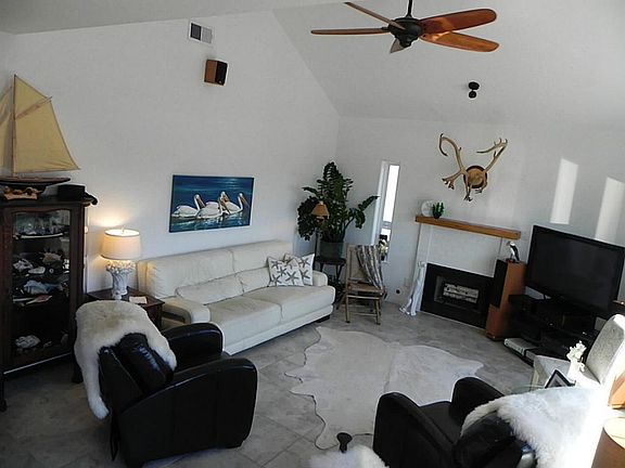 Bright Living Room boasts high ceilings. Propane or wood burning fire place.