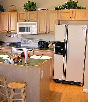 Kitchen with island, newer fixtures, new refrigerator (not shown)