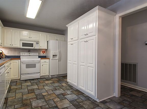 Kitchen has large pantry with pullout drawers