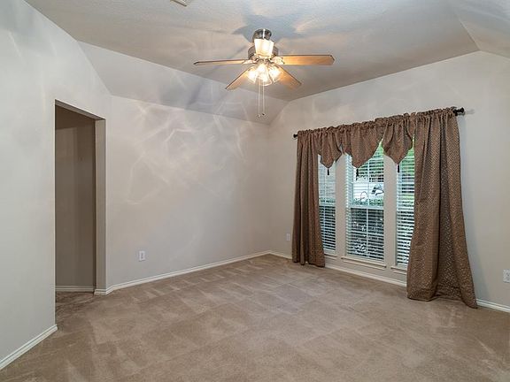 The formal dining room is very spacious and features a wall of windows with views to the front yard space! Cozy evenings spent at home enjoying a fabulous meal or playing cards with family can all be hosted here!