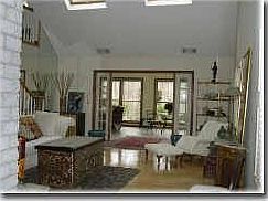 View of entrance to sunroom from living room w/hrdwd floor.