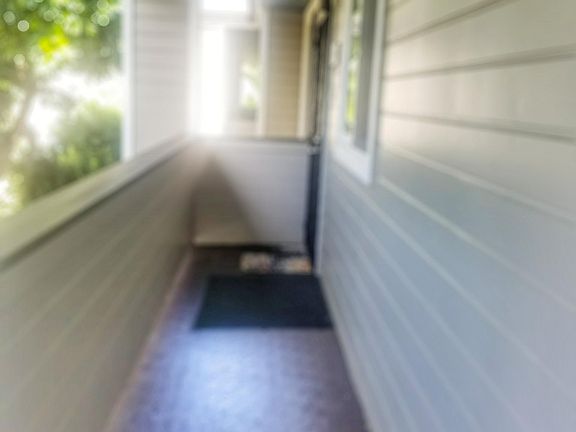 Up the stairs, looking down the walkway towards the front door.