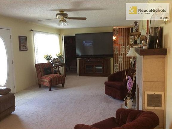 The guest closet off living room is cedar lined.  Stairway to recreation room is other side of spindles.
