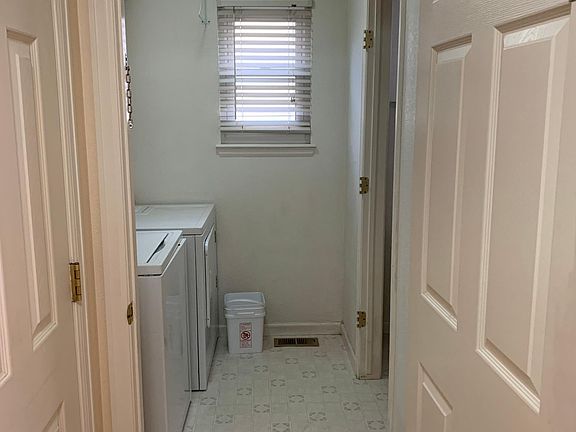 First floor entrance to laundry room. The closet door on the left and half bathroom on the right