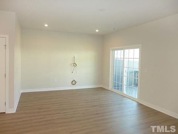 Living room with option for media LAN cables and opens to deck