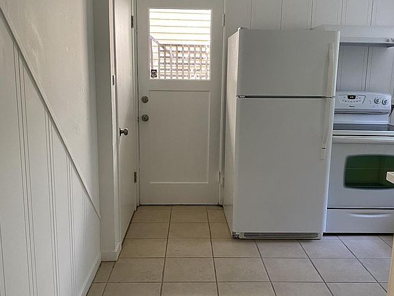 Inside the kitchen looking out the front door.