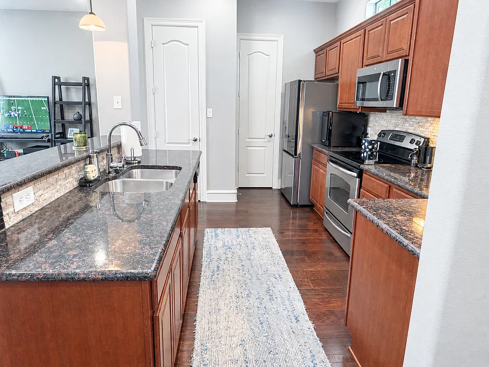 Oversized kitchen with new refrigerator and generous cabinetry. Half bath and pantry on this floor as well.