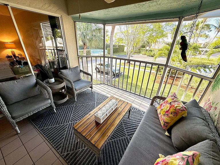 Outdoor living space looking over pool.