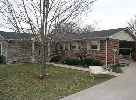 Concrete drive and sidewalk to covered entry.