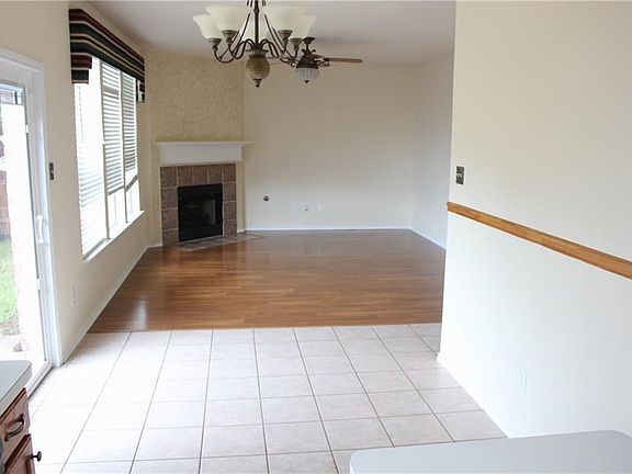 Family room with fireplace open to breakfast eating area and