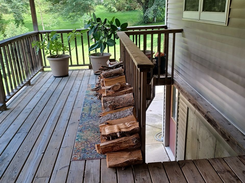 Stairs to the front door, part of the deck, and the side door to the garage.