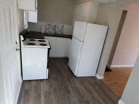 Fully functional and comfortable kitchen with new flooring, paint and back spash