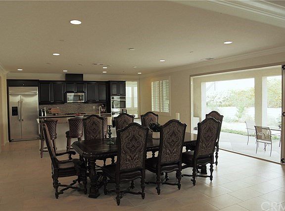 Dining room and kitchen with open bi-fold doors