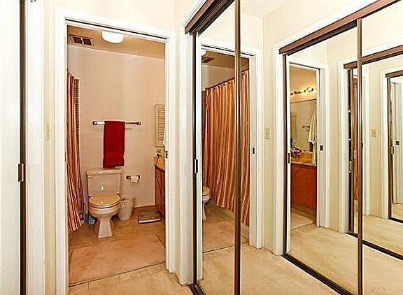 Master bath with two sinks and two closets in hall