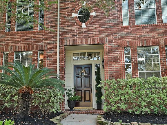 Full brick and sides, brick entry porch and solid wood door with sidelight and transom window.