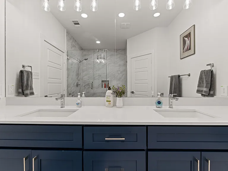 The Master Bath offers double sinks, a spa-like shower, and a privacy toilet room.