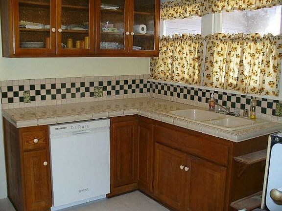 tiled countertops and glass cupboards