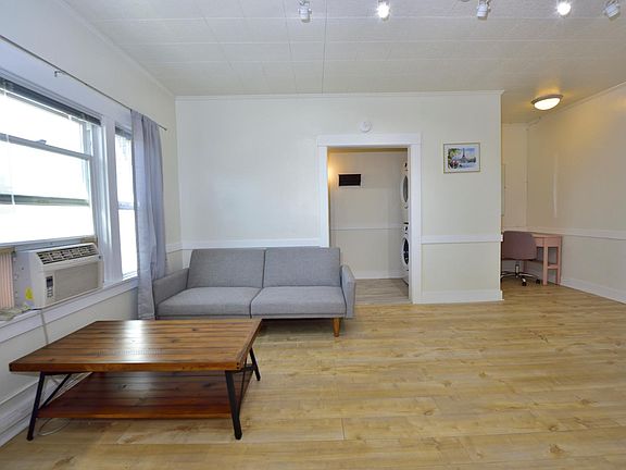 updated LARGE studio with many windows, furnished with in-unit laundry machines