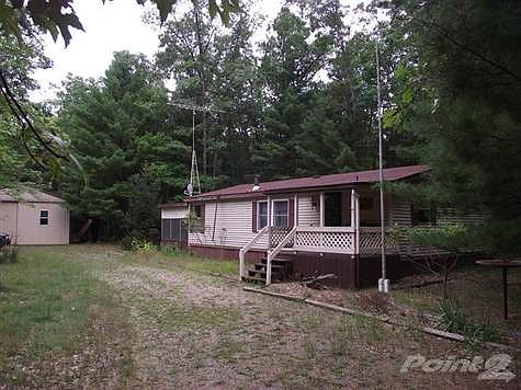 2 Bedroom home and pole barn in a private wooded setting.