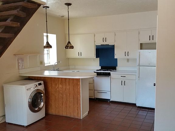 On the entry level, living room, kitchen and a super high efficiency washer/dryer. The white appliance shown both washes and dries the clothes.