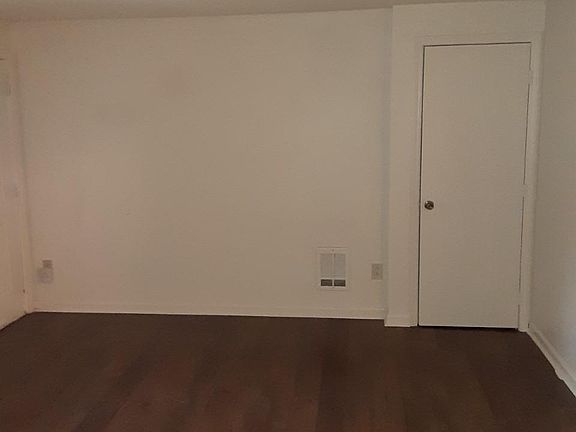 Living room with coat closet.