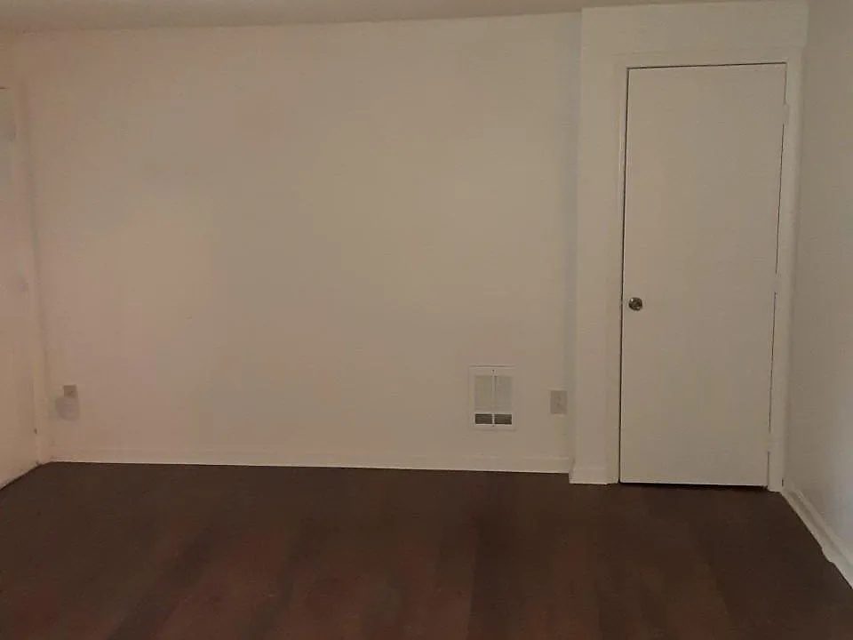 Living room with coat closet.